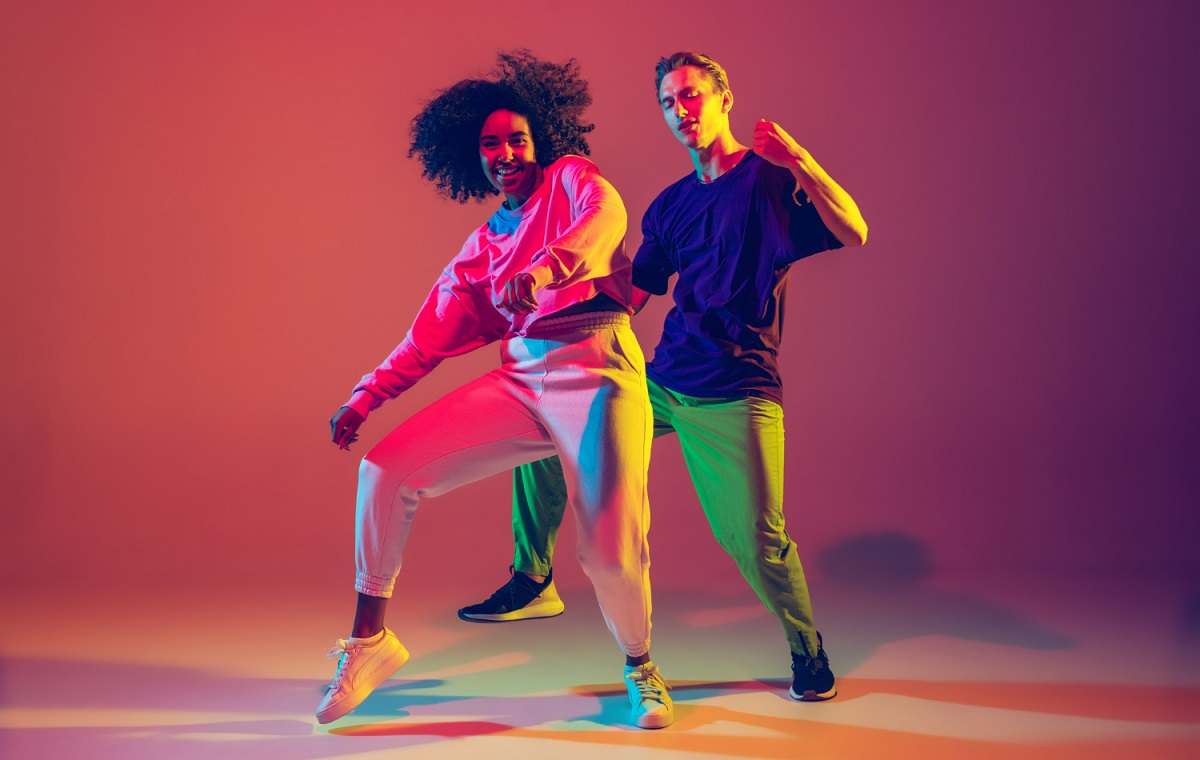 dance-time-stylish-men-and-woman-dancing-hip-hop-in-bright-clothes-on-green-background-at-dance-hall-in-neon-light.jpg