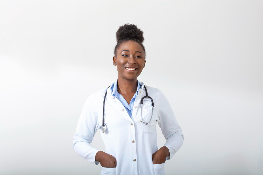 doctor-with-a-stethoscope-hand-in-her-pocket-closeup-of-a-female-smiling-while-standing-straight-on-white-background.jpg