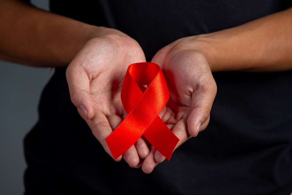 woman-hand-holding-red-ribbon-hiv-awareness-concept-world-aids-day-and-world-sexual-health-day.jpg