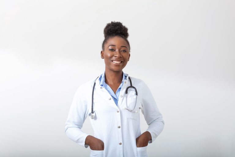 doctor-with-a-stethoscope-hand-in-her-pocket-closeup-of-a-female-smiling-while-standing-straight-on-white-background-768x512-1.jpg