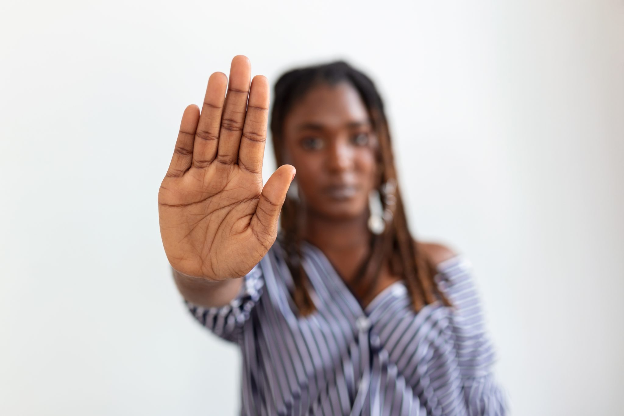 woman-raised-her-hand-dissuade-campaign-stop-violence-against-women-african-american-woman-raised-her-hand-dissuade-with-copy-space-scaled.jpg