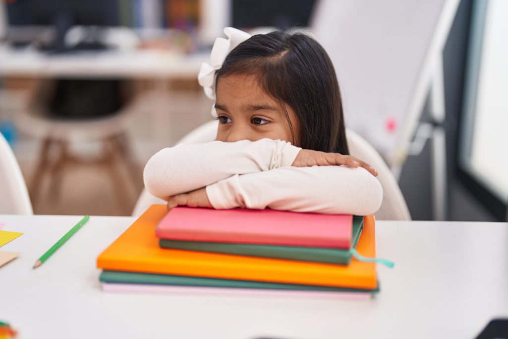 adorable-hispanic-girl-student-smiling-confident-leaning-book-classroom-1.jpg